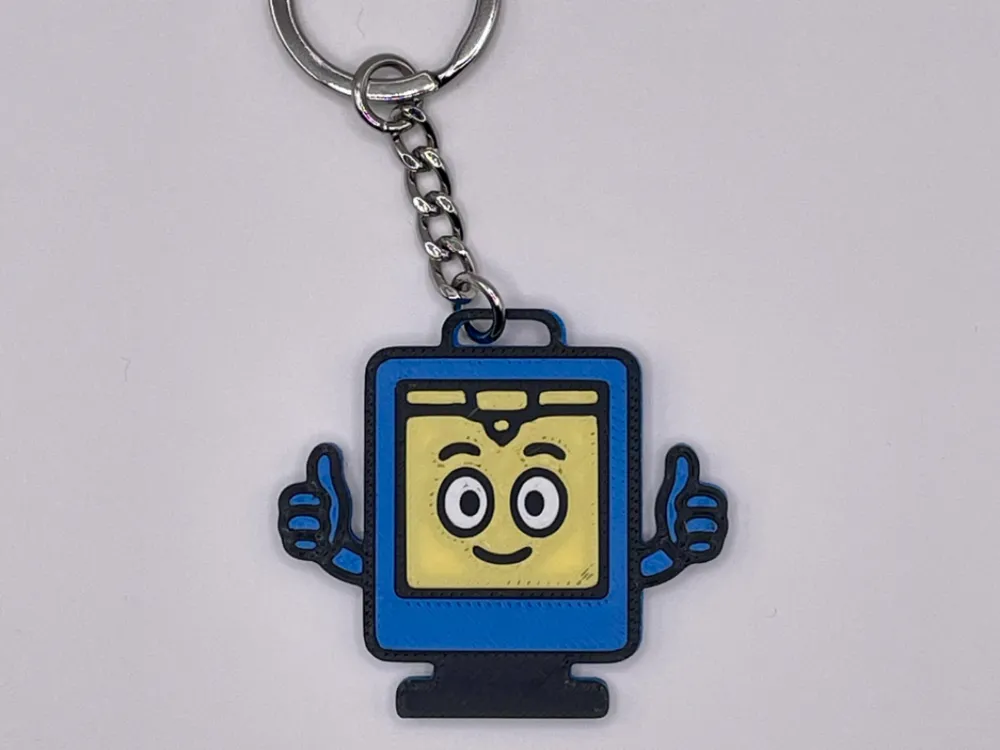 3D-printed printer buddy keychain with a smiling screen and thumbs-up