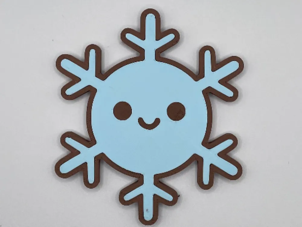 Snowflake fridge magnet with a smiling face