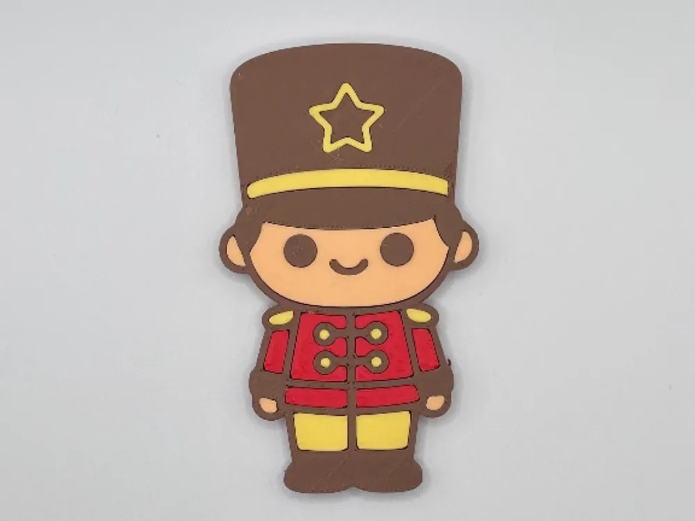 Toy soldier fridge magnet with red jacket and tall hat